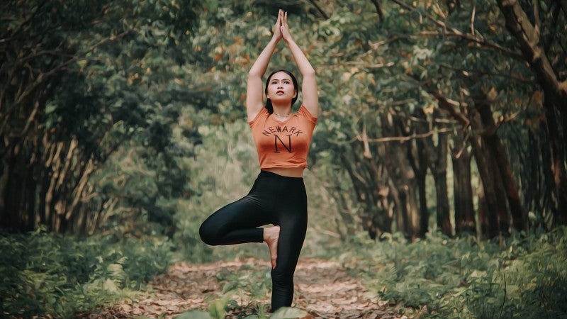 wellness lace pages yoga woman doing yoga in the woods